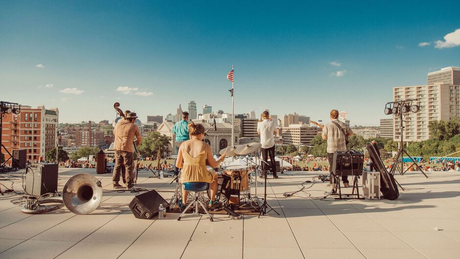 A band plays overlooking the skyline of Kansas City.